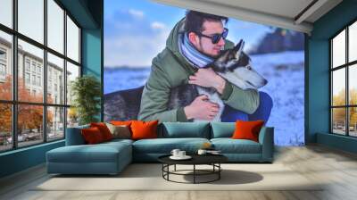 man in sunglusses hug`s his dog Wall mural